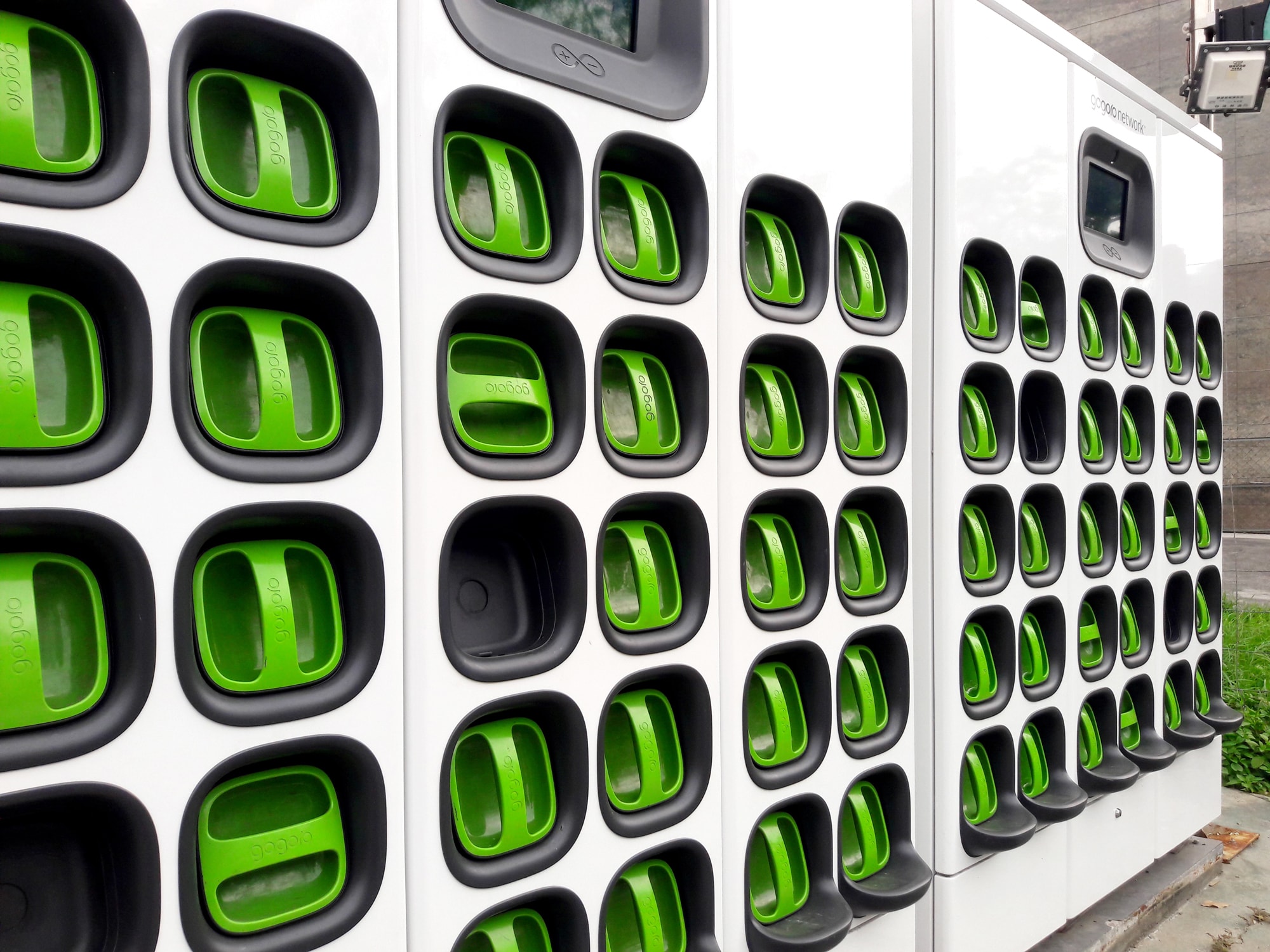 Figure 1: Batteries from Gogoro electric scooters can be removed, placed in the charging wall, and replaced by a fully charged battery.